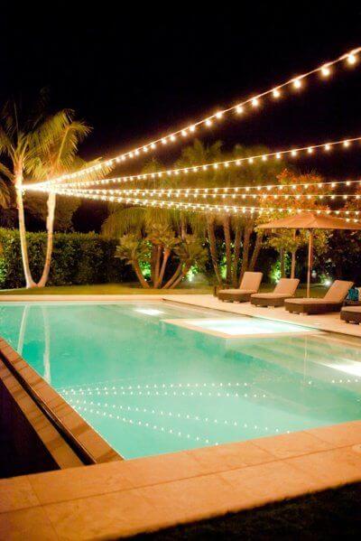 lighting backyard pool lights string above light around stylemepretty pond swimming night poolside christmas across put strung