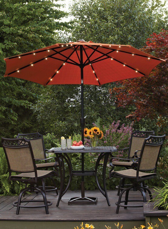 One excellent and unexpected way to provide functional backyard lighting to an outdoor dining area is with umbrella lights. Umbrella lights attach to your patio umbrella to provide light to the table underneath.
